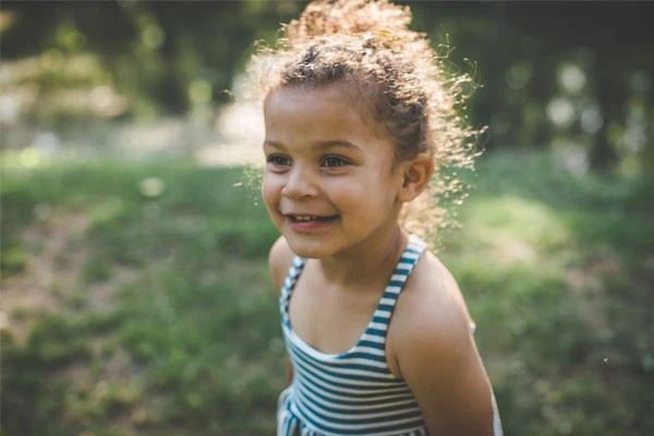 About Us - Adoptions of Indiana - A happy girl outside at a park