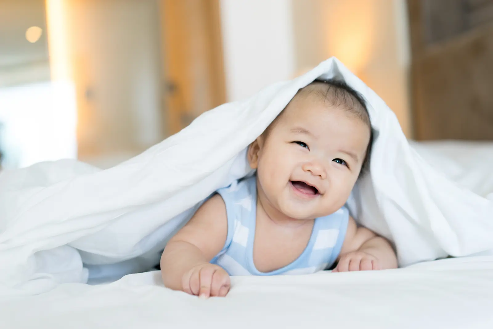 grinning baby under covers Adoption Counseling Support: Professional guidance for emotional well-being during the adoption journey