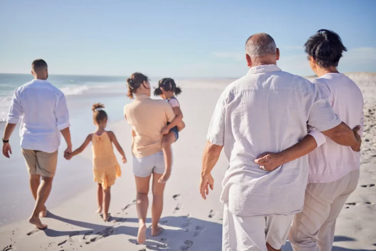 Adoption Agencies: Kids Walking Along Beach with Parents and Grandparents
