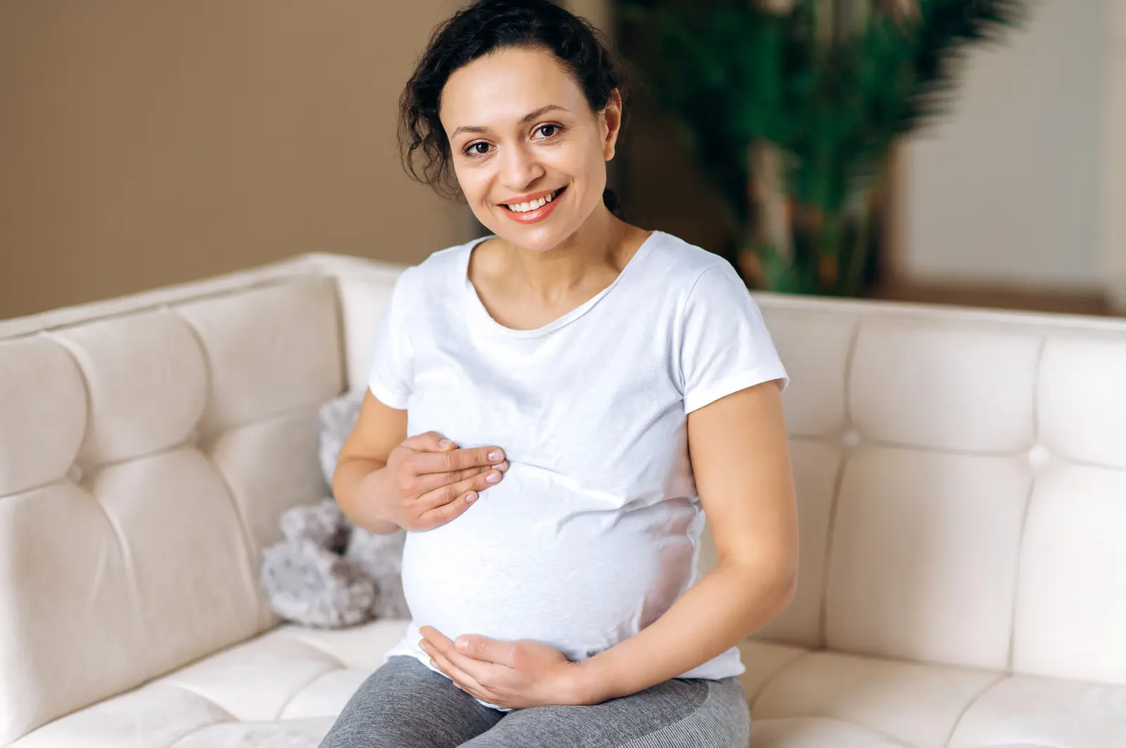 selecting Baby's Adoptive Family smiling woman holding pregnant-belly